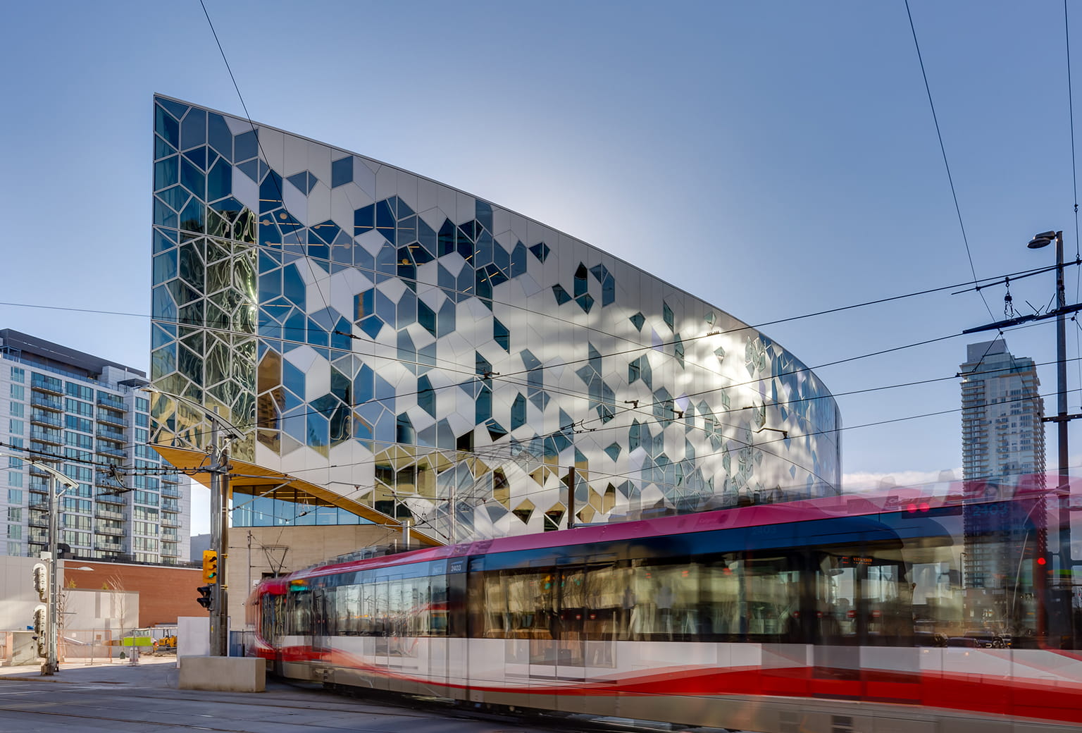 Alpolic Canada — Calgary Central Library with C-Train passing beneath the encapsulated LRT line, distributed by Exterior Technologies Group