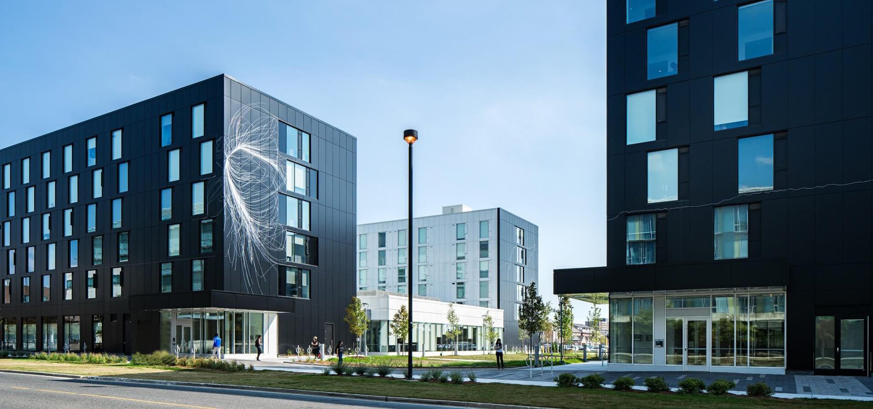 Matte black Alpolic residential mid-rise with art mural