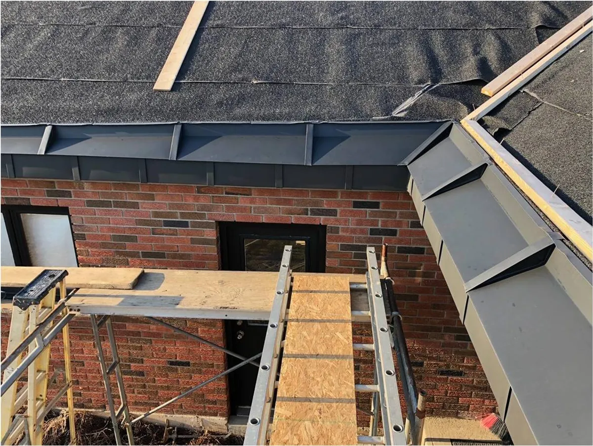 elZinc Canada — zinc flashing and trim detail on residential brick facade, supplied by Exterior Technologies Group