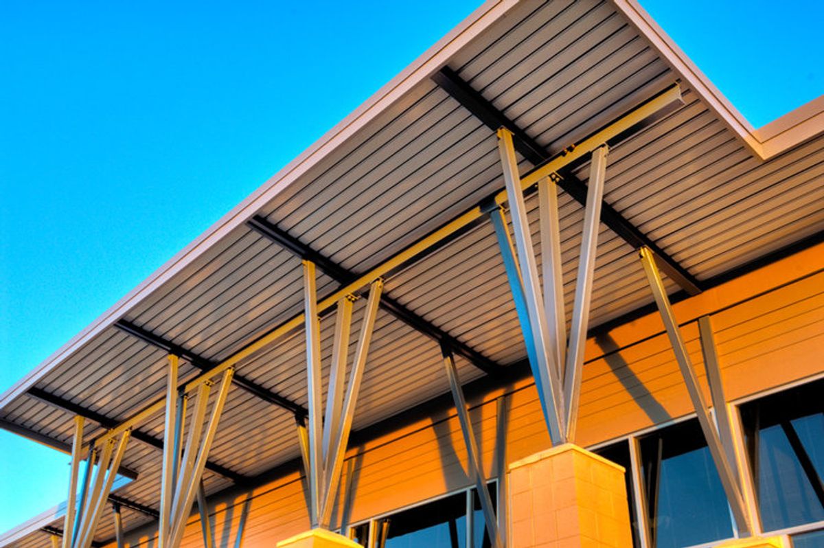 EPIC Metals Canada — exterior canopy soffit at sunset with diagonal steel supports, by Exterior Technologies Group