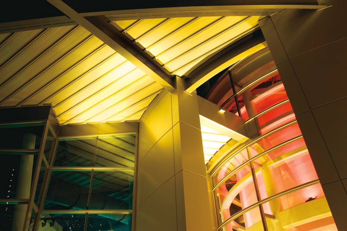 EPIC Metals Canada — illuminated structural deck canopy beside curved feature wall, supplied by Exterior Technologies Group